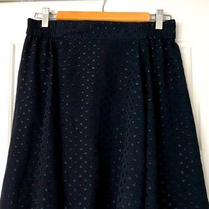 Asymmetrical navy skirt with sparkly polka dots